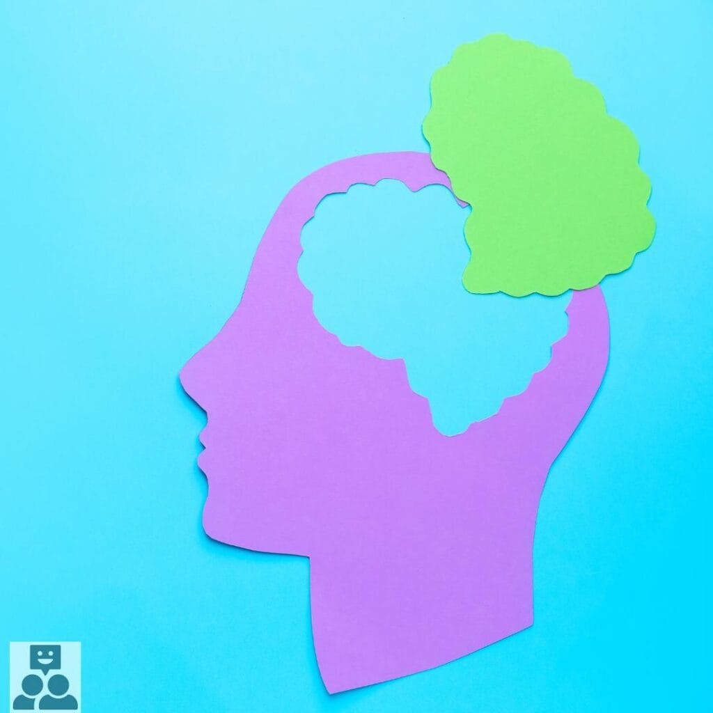 Ons geheugen, afbeelding van een papieren hoofd in het roze tegen een blauwe achtergrond, daarboven de hersenen in het groen. - Ik Wil Therapie - 